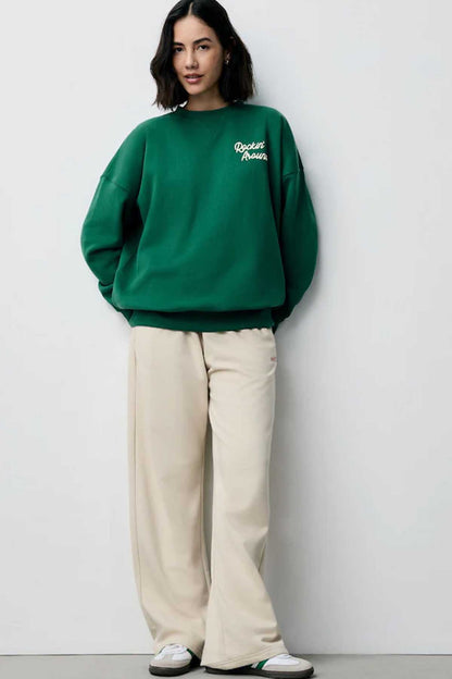 NEXT forest green crewneck sweatshirt with 'Rockin' Around' logo on chest