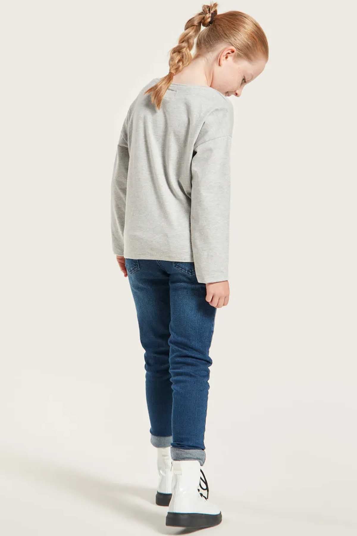 Kids blue denim jeans, side view with cuffed hem and stitched back yoke