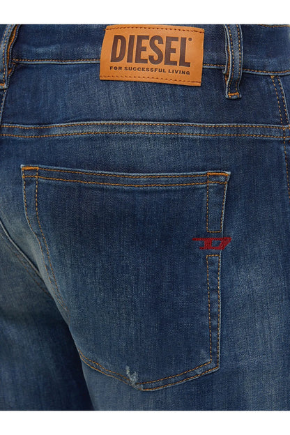 Blue denim jeans back pocket with orange Diesel logo patch and stitched seam