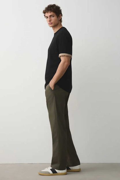 Men's khaki green straight-leg trousers with black short-sleeve T-shirt, side view