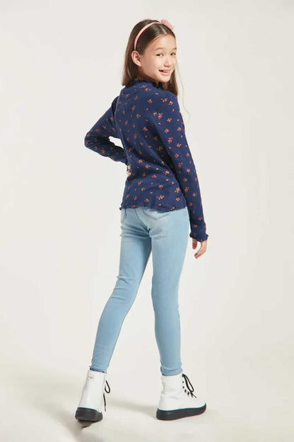 Girls navy long-sleeve patterned top with light-blue skinny jeans and boots