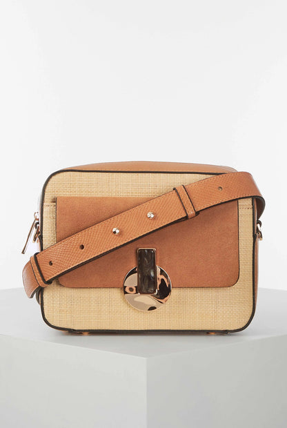 Brown crossbody bag with wide strap, front flap, and gold-tone clasp