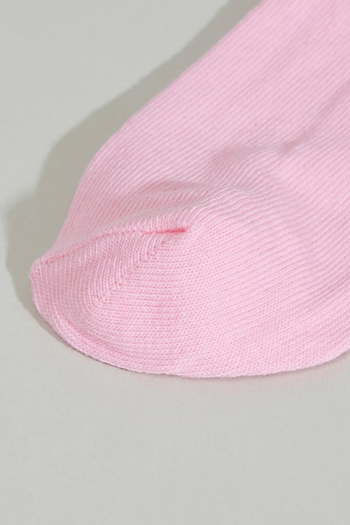 Pink baby sock with ribbed knit and folded cuff