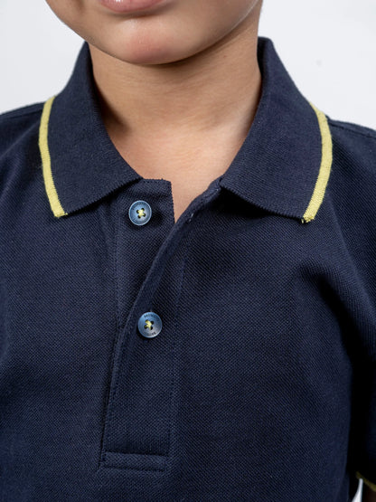 Kids navy polo shirt collar close-up with yellow edge and button placket