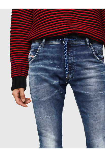 Indigo denim jeans close-up of waistband, belt loops, and stitched fly