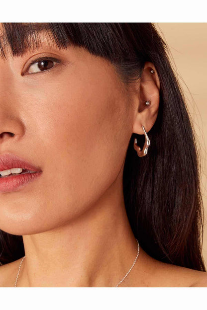 Silver hoop earrings with small stud detail, open loop design
