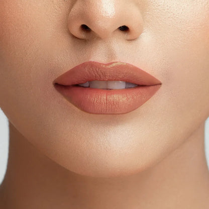 Velvet lipstick on lips in warm rose nude, smooth satin finish