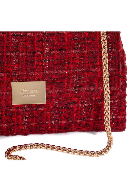 Red tweed handbag close-up with gold chain strap and logo patch