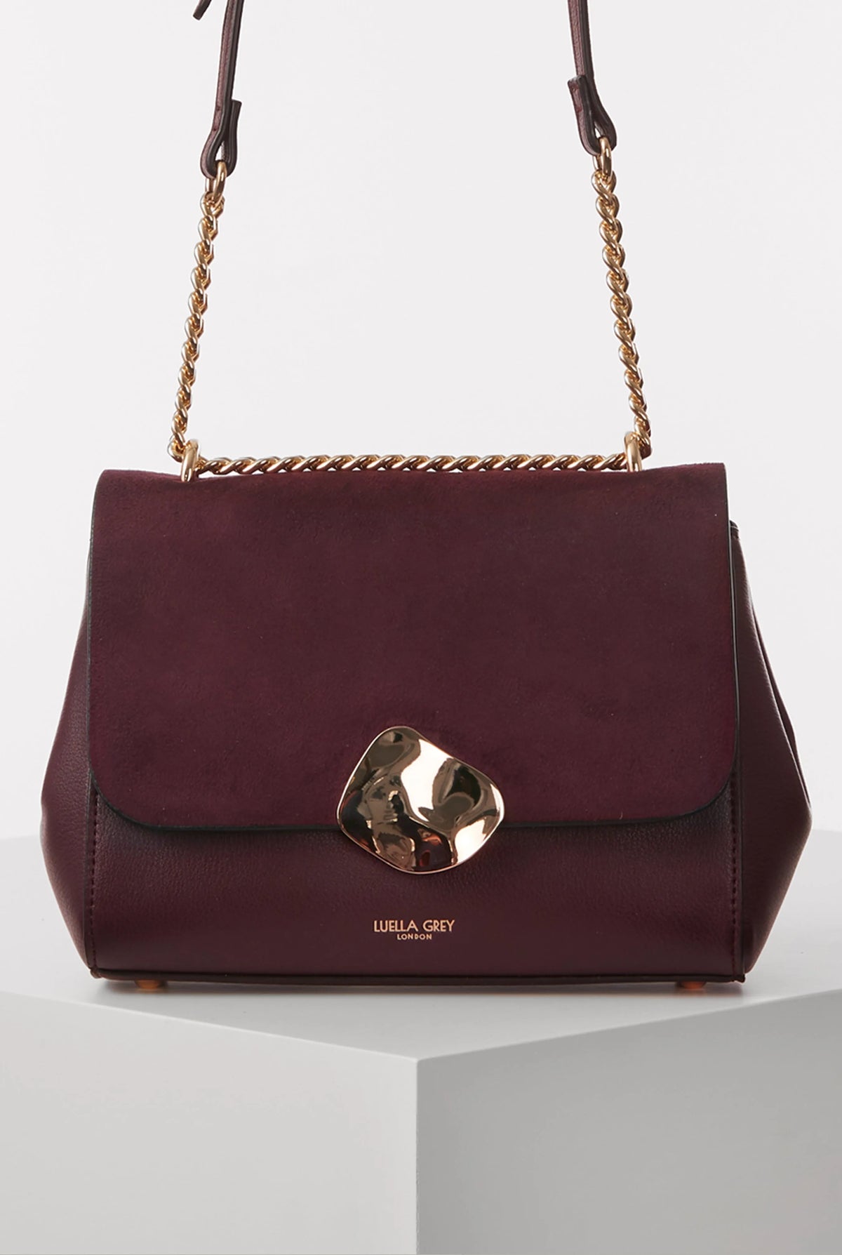 Burgundy leather flap shoulder bag with gold chain and metal clasp front