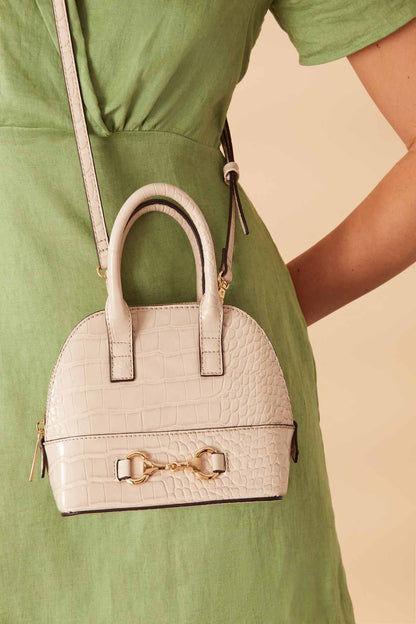 Cream faux-croc mini handbag with top handles and front buckle detail