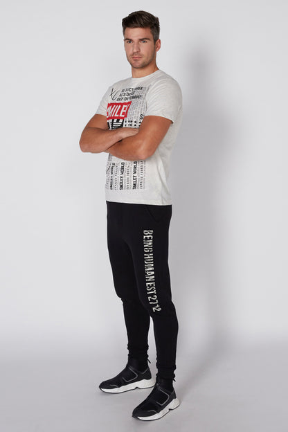 Men's white Smiley graphic T-shirt and black pants, full-length outfit