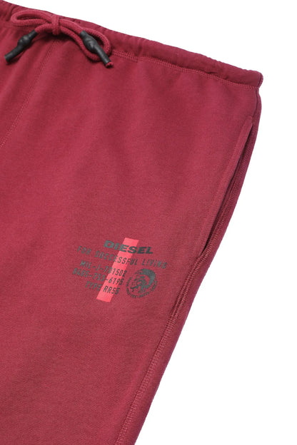 Maroon jogger pants close-up of logo print on the leg