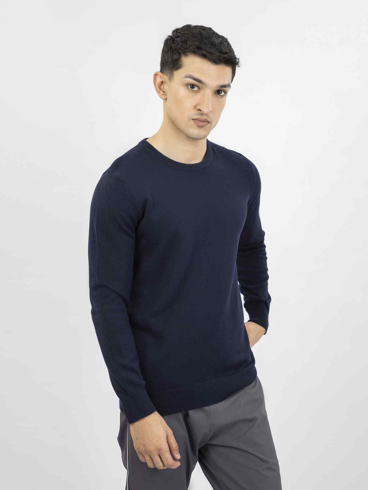 Men's dark blue crewneck knit sweater on-body view, long sleeves and ribbed hem