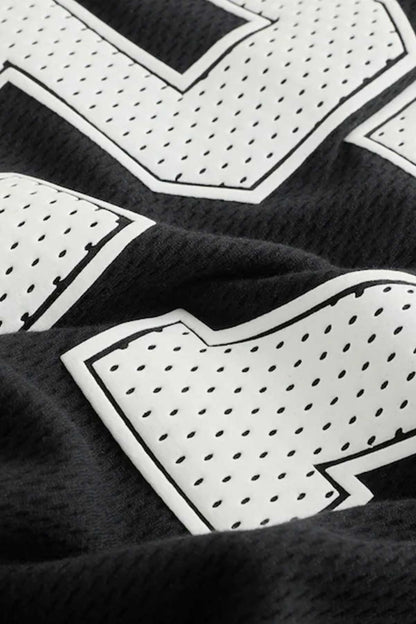 Black jersey fabric with white geometric pattern and outlined trim