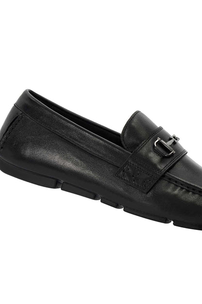 Black leather loafer side view with buckle strap detail and stitching