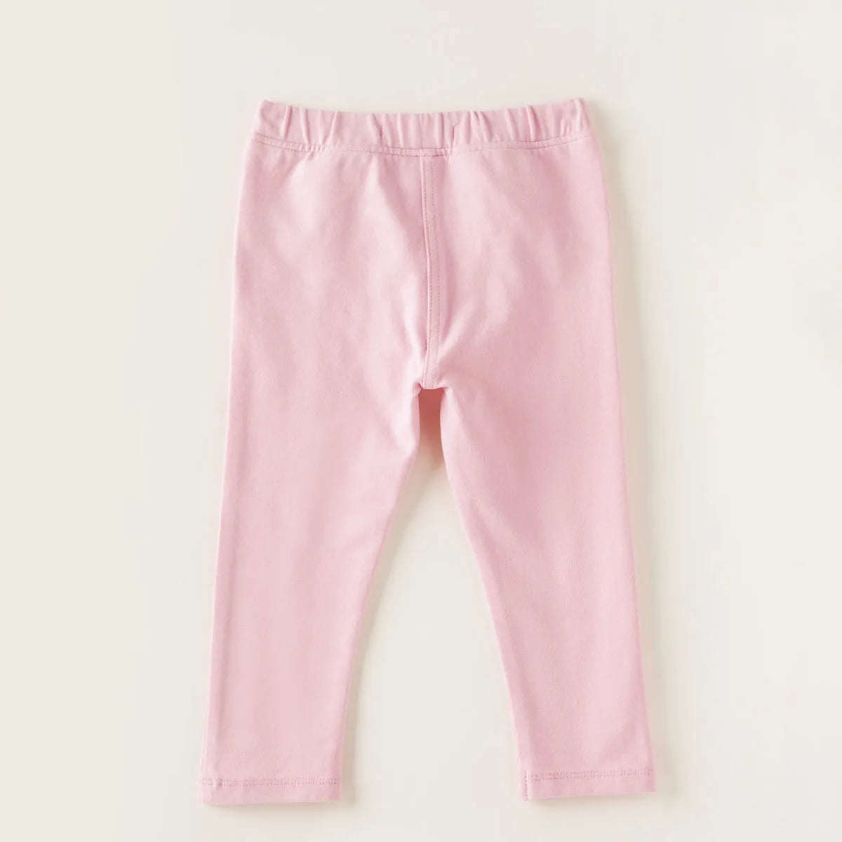 Pink baby pants with front center seam and elastic waistband