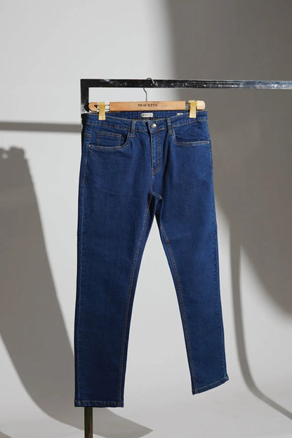 Blue denim jeans with front pockets, belt loops, and button closure