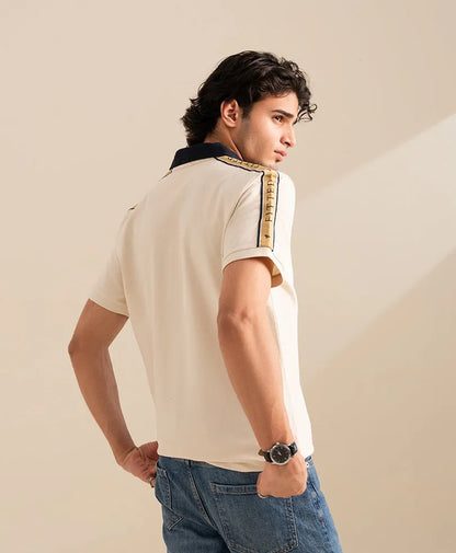 Fitted off-white polo shirt, navy-collared back view with sleeve stripe and logo detail.