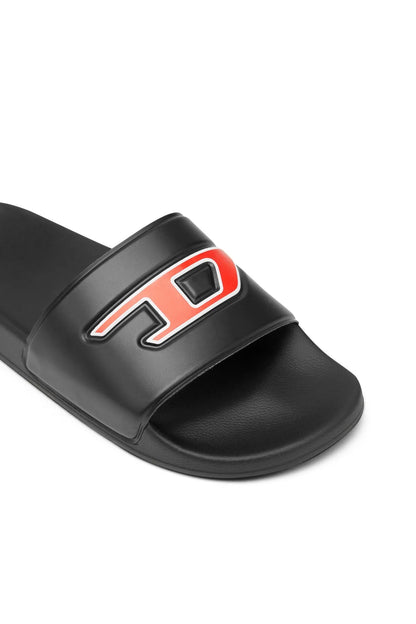 Black slide sandal strap close-up with red and white AC logo patch