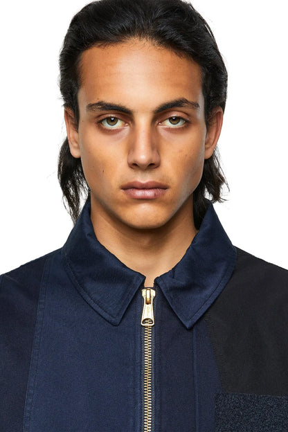 Blue bomber jacket with gold-tone front zipper and stand collar detail