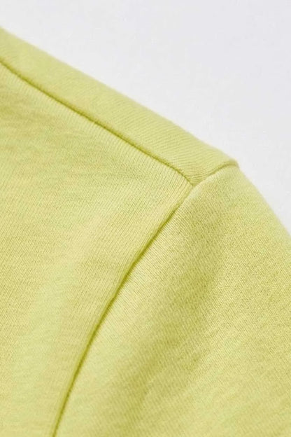 Lime green T-shirt shoulder seam and sleeve cuff knit detail