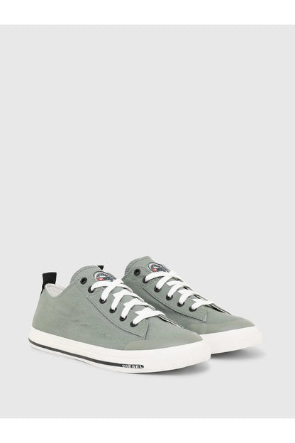 Pair of green canvas low-top sneakers with white laces and white rubber toe caps