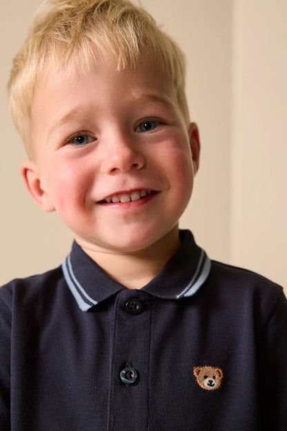 Navy kids polo shirt with button front and small bear emblem