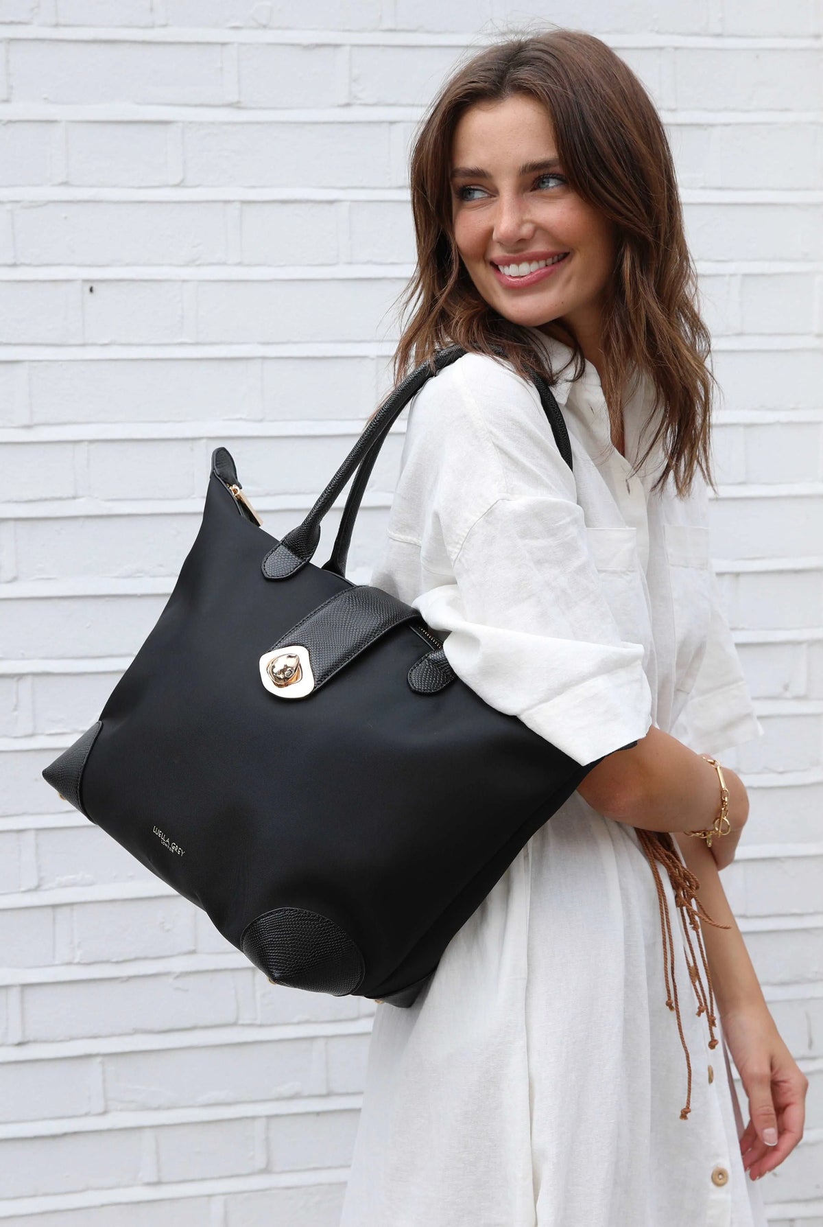 Black Luella Grey tote bag with gold clasp and two short handles