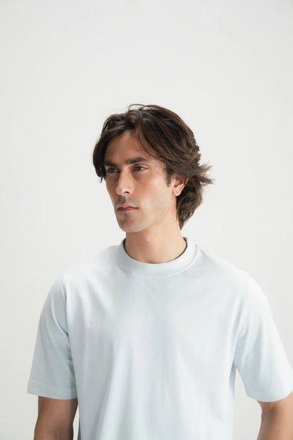 Blue crew-neck T-shirt close-up on model’s face and upper torso