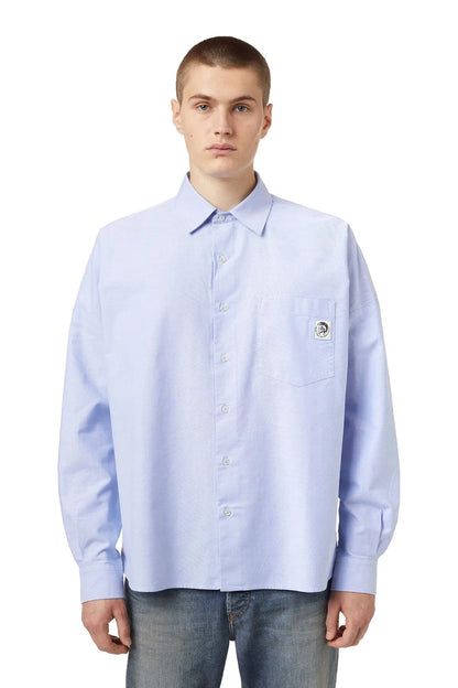 Men's light blue button-up dress shirt with logo patch and chest pocket