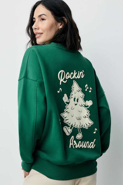 Forest green sweatshirt with 'Rockin' Around' tree music graphic on back