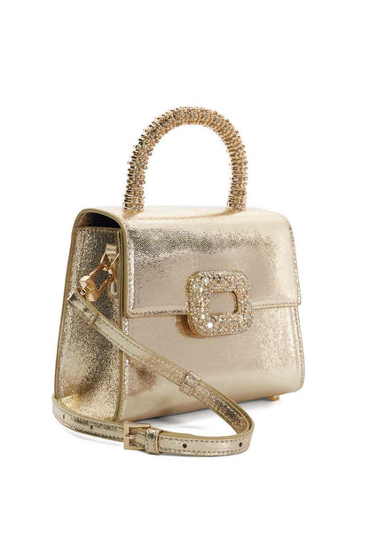 Gold mini handbag with beaded handle and rhinestone clasp, shown from side with strap