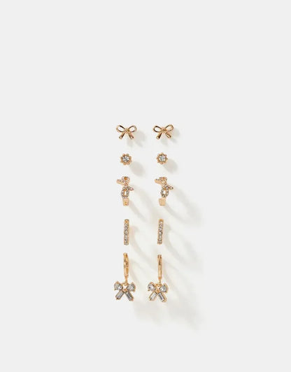 Gold-tone mixed earrings set with bow, star, and dangling crystal charms