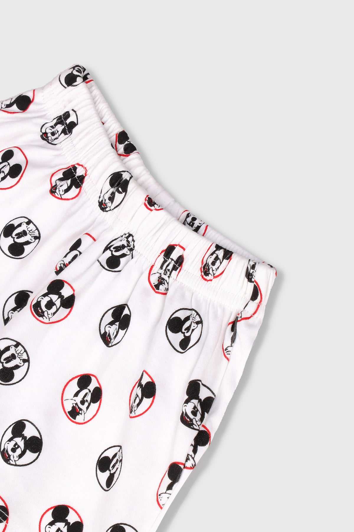 Kids DISNEY white shorts with repeating Mickey head and character icons pattern