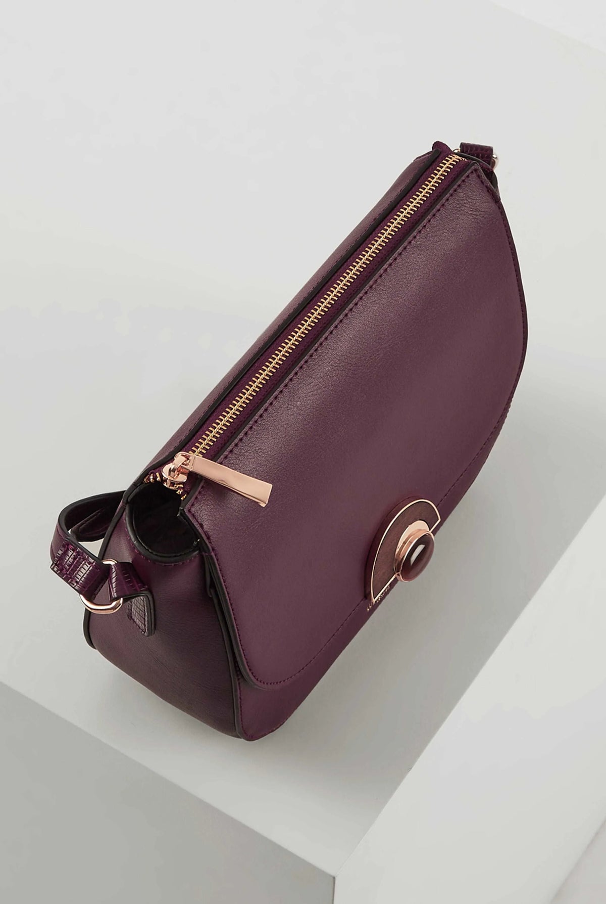 Berry leather crossbody bag with top zip, gold hardware, and turn-lock flap