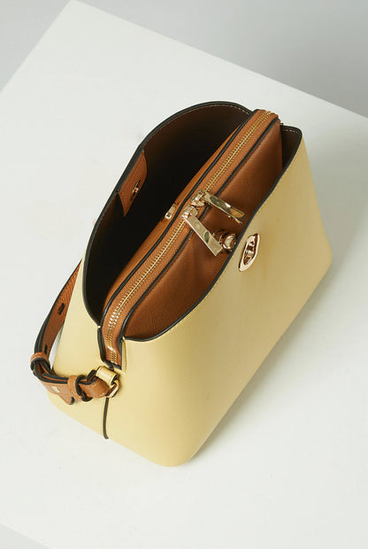 Yellow handbag with brown leather strap and gold hardware, angled side view