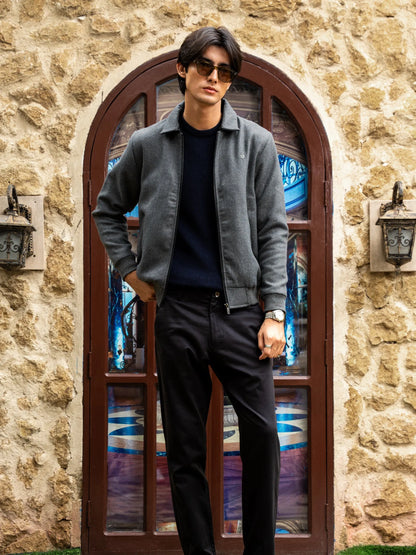 Grey zip-front jacket with mock collar worn with dark trousers