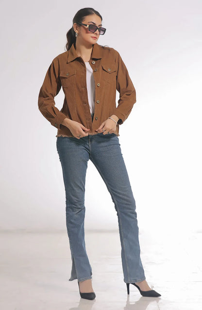 Tan utility jacket with button front, chest pockets, and long sleeves worn with jeans