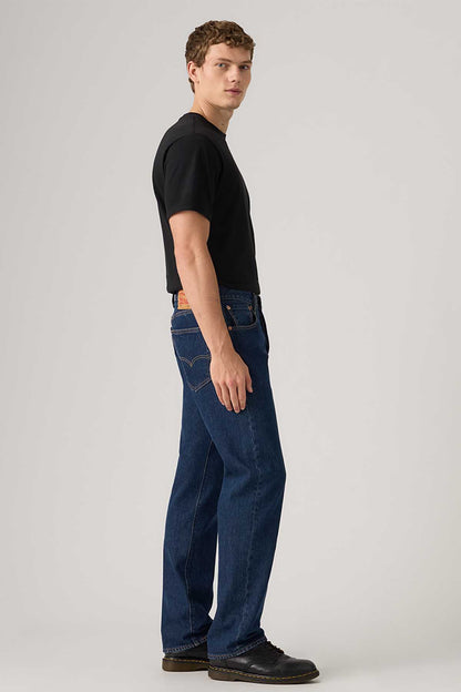 Dark indigo denim jeans, side view with straight leg and five pockets