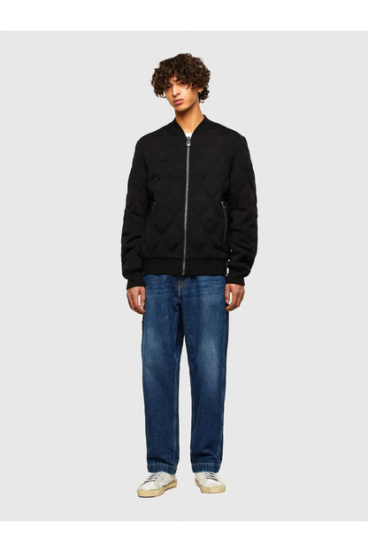 Black quilted bomber jacket with full zipper and stand collar, worn with jeans