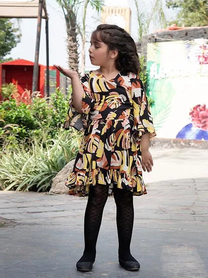 Kids zebra-print ruffled dress with black tights, side view