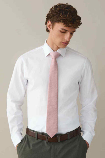 White dress shirt with pink necktie and brown belt, styled with dark trousers