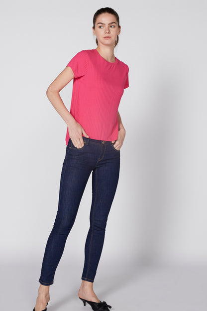 Pink short-sleeve crewneck knit top, worn with dark skinny jeans