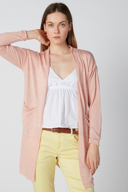 Pink long-sleeve open-front cardigan with draped hem over a white top