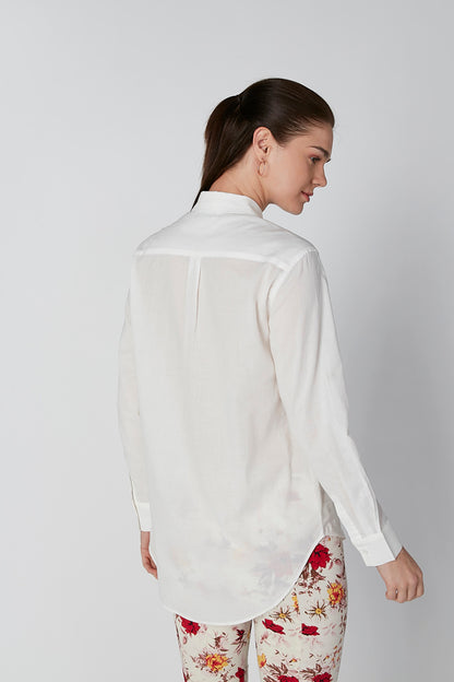 White button-up shirt and red floral print pants, back view