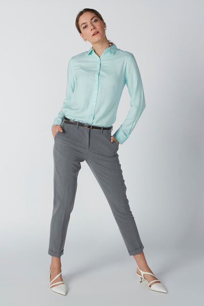 Light turquoise collared button-up shirt with long sleeves and front placket