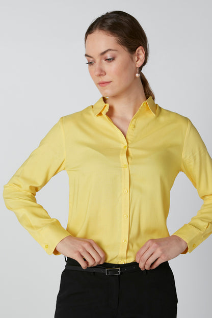 Yellow long-sleeve button-up blouse with pointed collar, front button placket