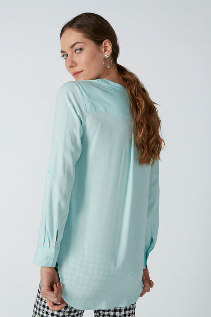 Light aqua long-sleeve blouse, relaxed fit with curved hem
