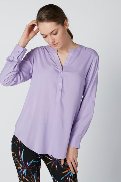 Lavender tunic-style blouse with V-neck placket and long sleeves
