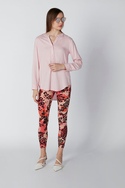 Pink long-sleeve button-up blouse, side view, curved hem